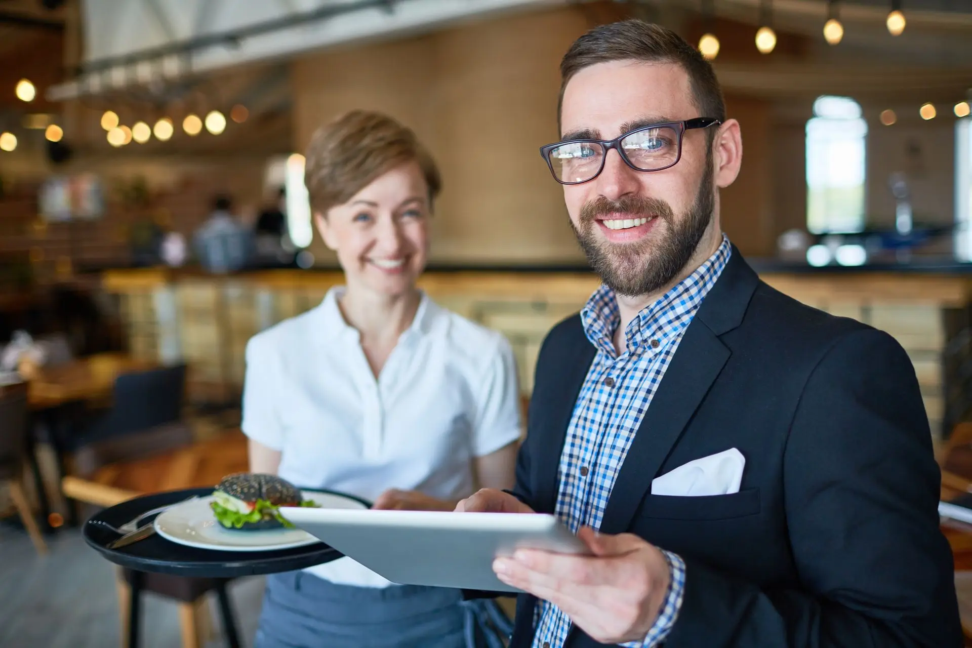 właściciel restauracji z księgowa zadowoleni z szybkiego wglądu w dane.